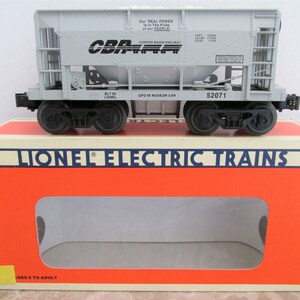 May include: A gray model train car with the words "Copper Basin Railway" and "GPD 53 Museum Car" printed on the side. The car is sitting on top of a box that says "Lionel Electric Trains".