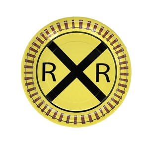 Op de afbeelding: Een gele papieren bord met een zwart spoorwegovergangssymbool en de letters "RR". De rand van het bord heeft een bruin spoorwegontwerp. Perfect voor een feest of evenement met een treinthema.