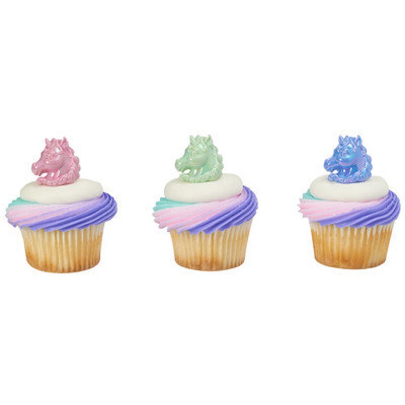May include: Three cupcakes decorated with pastel pink, green, and blue unicorn toppers. The cupcakes are frosted with a swirl of pastel pink, purple, and blue frosting.