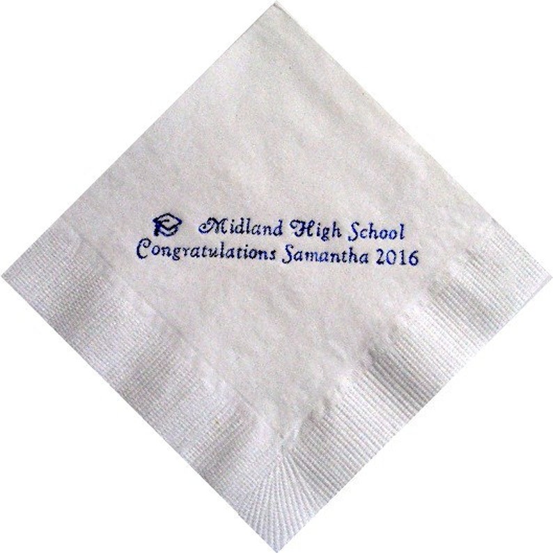 May include: White square paper napkin with a blue graduation cap graphic and text that reads "Midland High School Congratulations Samantha 2016". The napkin has a textured surface and is folded in a diamond shape.