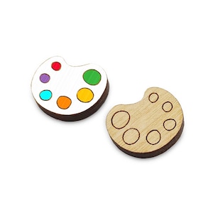 May include: Two wooden paint palettes, one with colorful paint swatches and one with blank spaces for paint.
