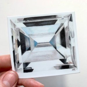 May include: A drawing of a square-shaped diamond with many facets. The diamond is drawn in shades of gray and white, with a hint of blue in the center. The drawing is signed "AK '17" in the bottom right corner.