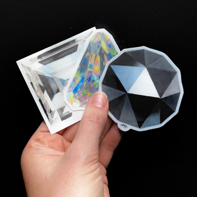 May include: Three sticker designs featuring different geometric shapes. The stickers are white with black and gray shading. The stickers are drawn to look like gemstones.