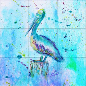 May include: A watercolor painting of a blue pelican perched on a wooden post. The background is a light blue with colorful splatter paint.