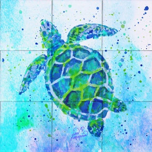 May include: A watercolor painting of a green sea turtle swimming in blue water with green and blue paint splatters. The turtle's shell is detailed with a green and blue pattern. The artist's signature, "Jan Marston", is in the bottom right corner.