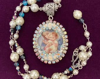 Mary and the baby Jesus Locket on pearled chain.