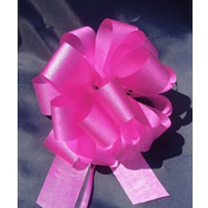 May include: A bright pink satin bow with a long tail. The bow is tied in a classic shape with multiple loops and is perfect for adding a touch of elegance to gifts or crafts.