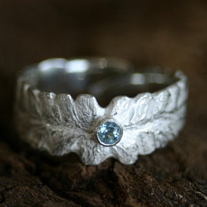 Wonderful silver ring in shape of a fern leaf with a waterblue topas
