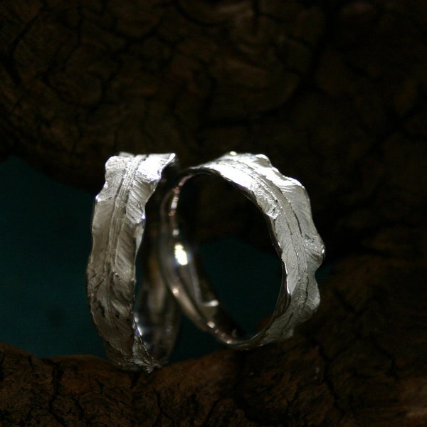 A pair of beautiful wedding rings in shape of fern leafs