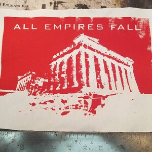 May include: A white patch with red background featuring a white silhouette of a building with columns and the text "ALL EMPIRES FALL" in white.