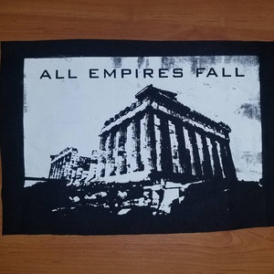 May include: Black and white patch with the text "ALL EMPIRES FALL" and a silhouette of a building with columns.