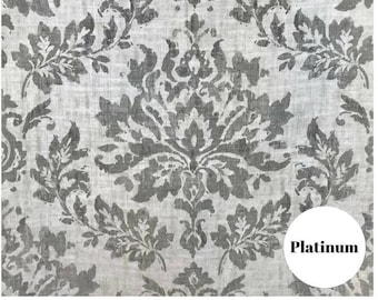 May include: A white fabric with a gray damask pattern. The fabric has a subtle linen texture. The word "Platinum" is written in black on a white circle in the lower right corner of the image.