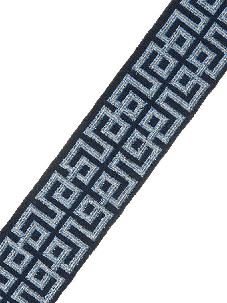 May include: Blue and white geometric patterned trim. The trim has a repeating pattern of squares and rectangles.