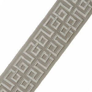 May include: A gray and white woven trim with a geometric pattern. The trim has a subtle sheen and is perfect for adding a touch of elegance to any project.
