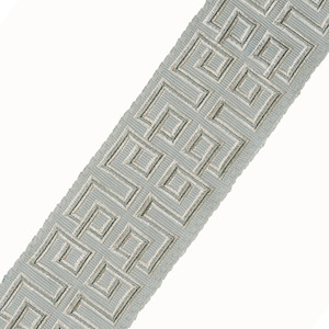 May include: A light blue trim with a silver geometric pattern. The trim has a subtle sheen and a slightly textured surface.