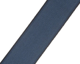 May include: A dark blue ribbon with a black edge. The ribbon is woven with a subtle texture.