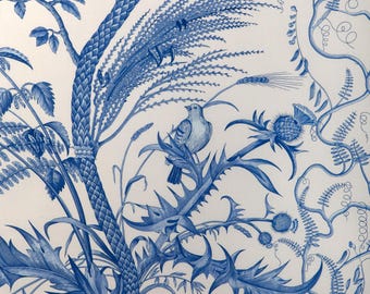 May include: A detailed blue and white botanical illustration featuring a bird perched on a thistle. The design includes various plants, leaves, and branches, creating a classic, elegant pattern. The artwork is reminiscent of traditional toile designs.