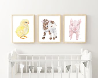 May include: Three framed watercolor paintings of baby animals. The first painting shows a yellow chick, the second shows a brown and white goat, and the third shows a pink pig.
