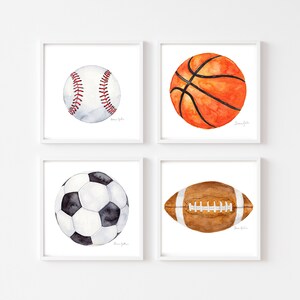 May include: Set of four watercolor paintings of sports balls: baseball, basketball, soccer ball, and football. Each ball is painted in realistic detail with white backgrounds.