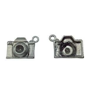 May include: Two silver camera charms, one with the lens facing forward and the other with the lens facing backward.
