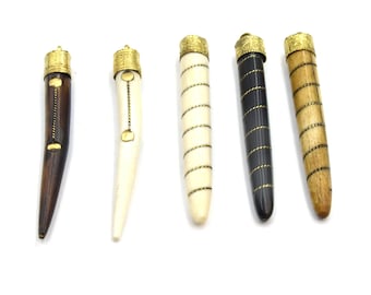 May include: Five decorative pen holders with gold-colored metal caps. The pen holders are made of different materials, including dark brown wood, bone, and black and tan materials. Each pen holder has a unique design.