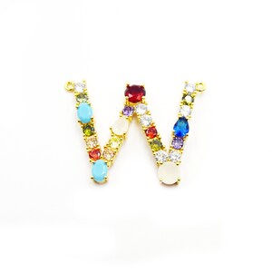 May include: Gold letter W charm featuring colourful gemstones and white stones. The charm is ideal for adding a personalised touch to necklaces, bracelets, or keychains.