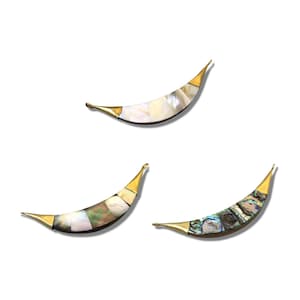 May include: Three crescent moon shaped metal charms with abalone shell inlay. The charms are gold colored with a variety of abalone shell patterns.