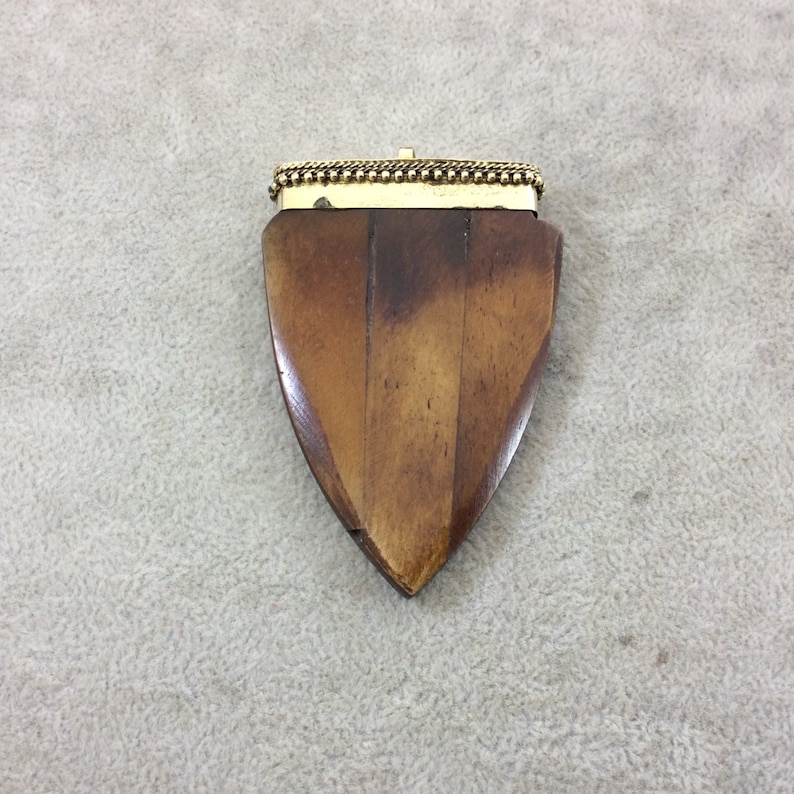 TR25WBRAAZ 2.5 Warm Brown Rounded Arrow Shaped Natural Ox Bone Pendant with Dotted Gold Cap Approximately - Measuring 45mm x 68mm