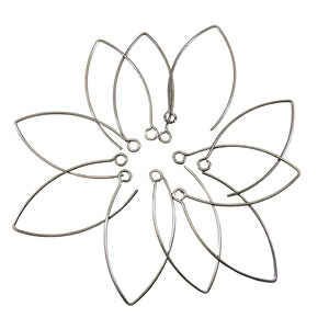 May include: A set of ten silver-toned earring hoops with a teardrop shape. The hoops are arranged in a flower-like pattern.