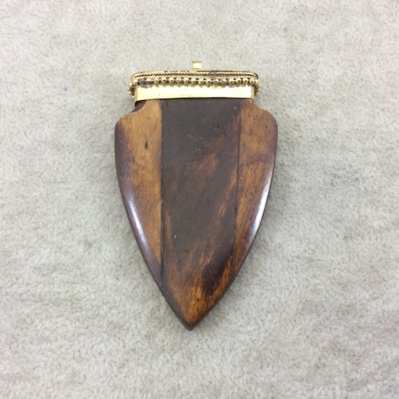 Measuring 45mm x 70mm TR275WBNFA Approximately - 2.75 Warm Brown Notched Arrow Shaped Natural Ox Bone Pendant with Dotted Gold Cap