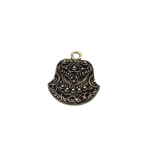 May include: A gold-toned metal pendant with a black filigree design. The pendant is shaped like a bell with a rounded top and a scalloped bottom.