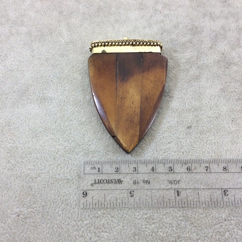 TR25WBRAAZ 2.5 Warm Brown Rounded Arrow Shaped Natural Ox Bone Pendant with Dotted Gold Cap Approximately - Measuring 45mm x 68mm