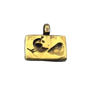 May include: A gold-toned pendant with a rectangular shape and a design of two stylized hearts. The pendant has a loop at the top for attaching a chain.