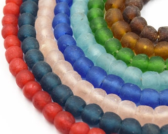 May include: A collection of colorful, round glass beads arranged in curved rows. The beads display a spectrum of colors, including red, teal, pink, blue, green, and brown. The beads are strung together, creating a rainbow effect.