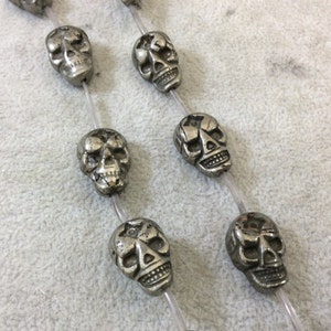 Metallic Pyrite Skull Beads: 13mm x 18mm, 15.25&quot; Strand