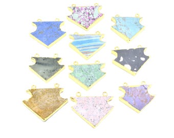 May include: A collection of gemstone pendants in various colors and patterns. Each pendant has a gold-colored frame and a unique stone, including blue, green, purple, and patterned designs. The pendants are displayed on a white background.