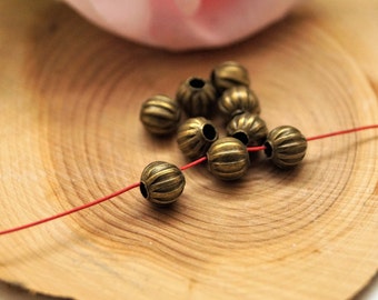 Perles rondes en métal bronze 6 mm par 25