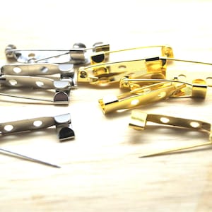 Épingles support broches en métal 2 trous 25*5 mm