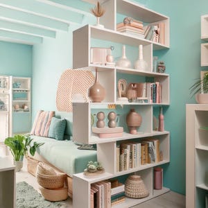 May include: A white bookshelf with a unique, asymmetrical design. The shelves are filled with books, decorative vases, and other objects. The bookshelf is in a room with light blue walls and a light green sofa.