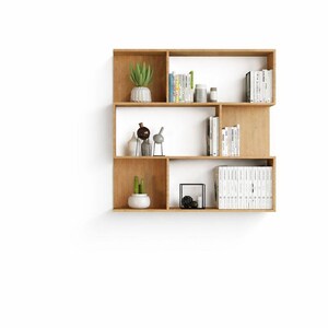 Modern wooden wall-mounted bookshelf with open compartments, shown isolated on a clean white background.
