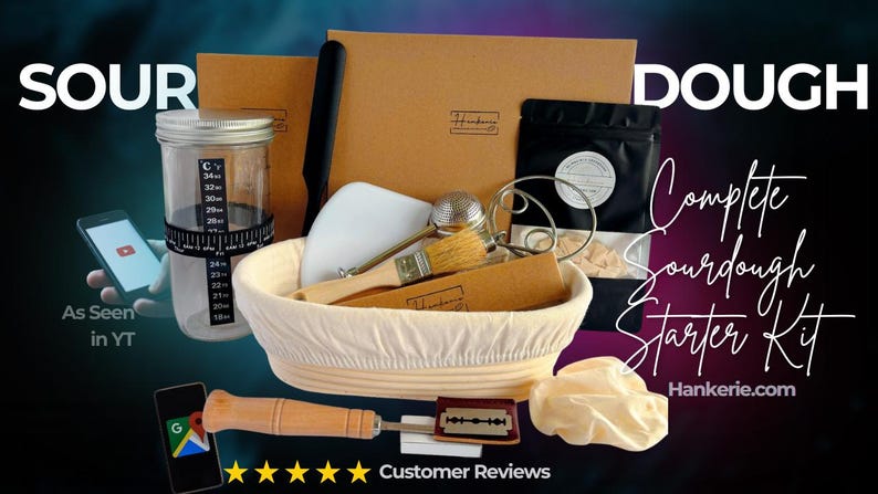 May include: A sourdough starter kit featuring a proofing basket with a cloth liner, a glass jar with a temperature strip, a wooden-handled lame with a razor blade, a pastry brush, a dough scraper, a whisk, and a black pouch labeled Hankerie.
