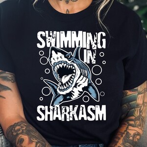 Swimming In Sharkasm Shirt, Ocean Lover, Cute Shark Pun, Funny Shark Lover Gift - Sweatshirt, Hoodie, Tank Top, V-neck, Long sleeve, Kids