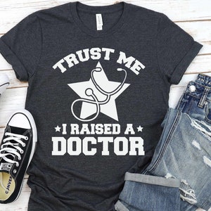 Raised A Doctor Shirt, Doctor Day, New Doctor, PhD Graduation, Funny Doctor Mom Gift - Sweatshirt, Hoodie, Tank Top, V-neck, Long sleeve