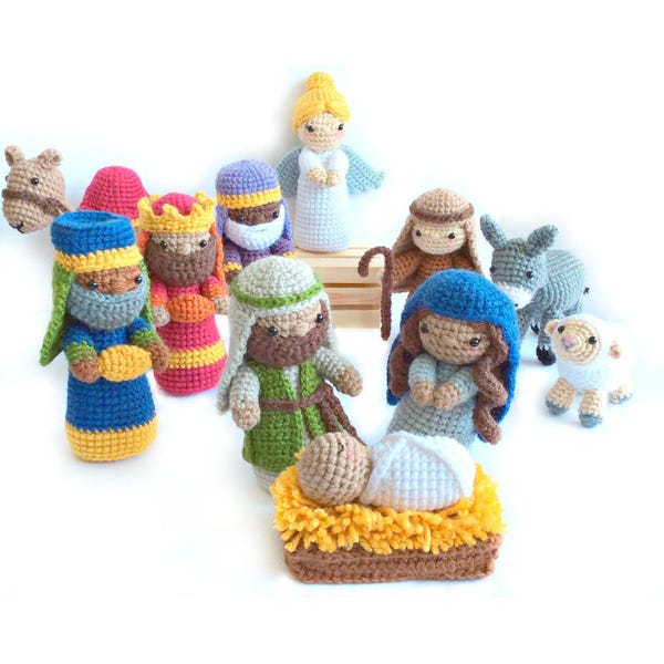 May include: A crocheted nativity scene with a variety of characters, including Mary, Joseph, baby Jesus, the three wise men, a donkey, a sheep, and an angel. The figures are all made of yarn and are brightly colored.