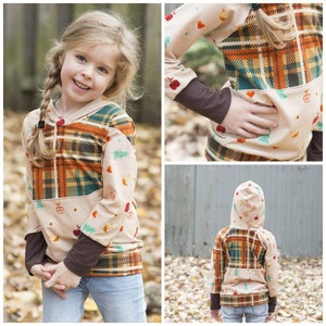 May include: A hooded sweatshirt with a plaid pattern on the top half and a brown, cream, and green pattern on the bottom half. The sweatshirt has brown cuffs and a hood. The sweatshirt is being worn by a child.