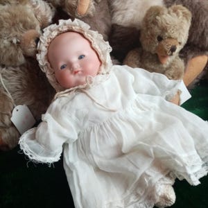 Antique Dream Baby by Armand Marseille, bisque character AM with blue glass eyes , Cloth baby body