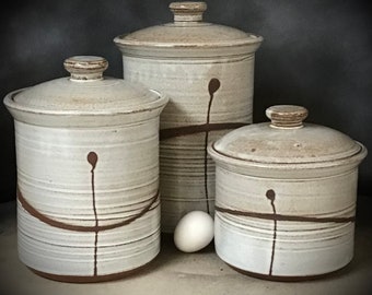 Handmade White Stoneware Kitchen Canister Set     three piece set, with lids    largest canister is 11" tall and will hold 15 cups.