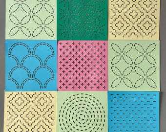 May include: Nine different square paper stencils with various geometric patterns. The patterns are cut out of the paper, creating a design that can be used for crafts or decorating.