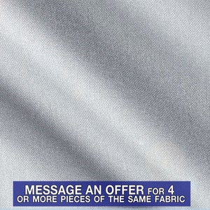 May include: A close-up of a silver fabric with a subtle textured pattern. The fabric is smooth and has a slight sheen. The text "MESSAGE AN OFFER for 4 OR MORE PIECES OF THE SAME FABRIC" is printed in blue at the bottom of the image.