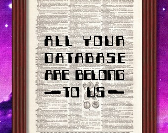 May include: A framed print with a vintage dictionary page background. The text "ALL YOUR DATABASE ARE BELONG TO US" is printed in a pixelated font.